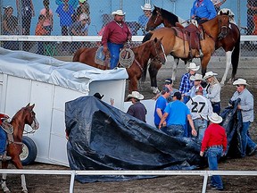 Roger Moore's wagon pulls up on the back stretch after finishing the race in heat 5 of the 2017 GMC Rangeland Derby at the Calgary Stampede. One of his horse was taken away in the horse ambulance.
