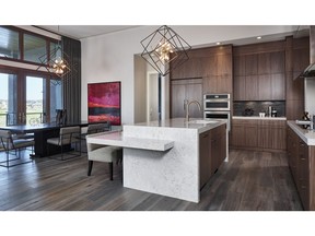 The kitchen and dining area in the Carmini II bungalow by Albi Luxury by Brookfield Residential in Artesia at Heritage Pointe.