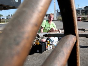 University of Calgary engineering student Sam Pollock studies the poll on Jason Glass' chuckwagon at Calgary Stampede, Thursday July 6, 2017. Leah Hennel/Postmedia