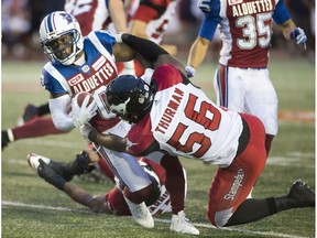 Montreal Alouettes' Stefan Logan (0) breaks away from Calgary Stampeders' Jameer Thurman during first half CFL football action in Montreal, Friday, July 14, 2017.