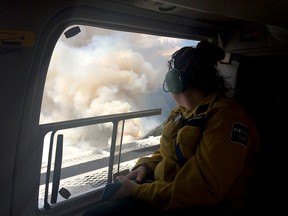 Parks Canada employee surveys the Verdant wildfire from the air near Sunshine Village.