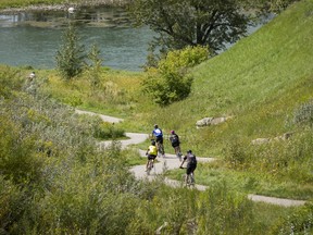 Cyclists cruise downhill from Cranston into Fish Creek Provincial Park on the Rotary/Mattamy Greenway path in Calgary, Alta., on Saturday, Sept. 3, 2016.