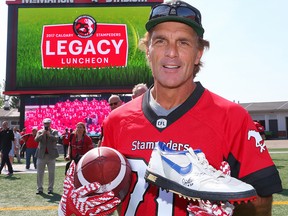 CFL legend Doug Flutie holds up the shoe on Friday, July 28, 2017 that came flying as he scored the winning touchdown in the 1992 Western Final, sending the Stamps to the Grey Cup. The members of the Calgary Stampeders 1992 Grey Cup-championship will be honoured during the legacy game this weekend. Al Charest/Postmedia