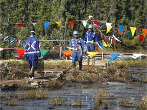 Crews work to contain and clean up a pipeline spill at Nexen Energy's Long Lake facility near Fort McMurray, Alta., Wednesday, July 22, 2015.