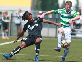 Calgary Foothills FC defender Dean Northover (R) battles against Victoria Highlanders FC midfielder Fabien Kurimata during PDL soccer action at the Calgary Soccer Centre in Calgary on Sunday July 16, 2017. Jim Wells//Postmedia