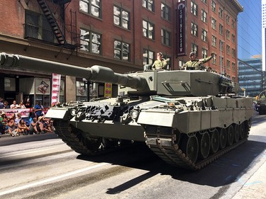 An army tank rolls down the street during the Stampede parade. Thousand of people came out to take in the 2017 Calgary Stampede Parade.These kids were having a great time.Friday July 7, 2017 in Calgary, AB. DEAN PILLING/POSTMEDIA