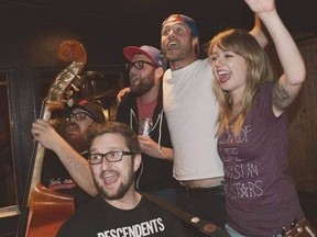 Eric Andrews (left, holding bass) and Rob Gruszecki (bottom left) host a singalong of punk rock songs on the Ship and Anchor's patio on Mondays during July and August.