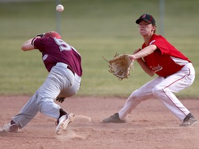 Ontario West Twins Robbie Bleich takes a throw to the head against Calgary's Fish Creek All Stars during Little League baseball action at        the Richmond Green Ball Diamond in Calgary, on Sunday.