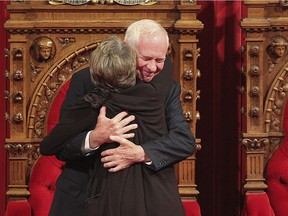 David Johnston hugs his wife Sharon during his installation ceremony inside the Senate in 2010.