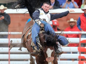 Steven Peebles of Richmond, Ore., scored a 90.50 on Yipee Kibitz to win the bareback event at the Calgary Stampede rodeo, Tuesday July 11, 2017. GAVIN YOUNG/POSTMEDIA