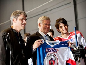 Former prime minister Stephen Harper poses along with Calgary's Bruce Callow with the jersey of Costa Rica's El Castillo Knights. Supplied photo