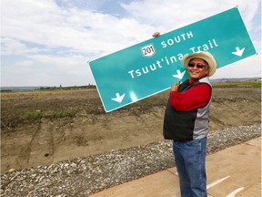Lee Crowchild, chief of the Tsuut'ina Nation, holds up the road sign as he was on hand to officially mark the start of construction on the southwest section of the Calgary ring road.