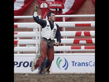 Richie Champion of Dublin, Texas celebrates his win in the bareback championship at the Calgary Stampede on Sunday July 16, 2017. Leah Hennel/Postmedia
