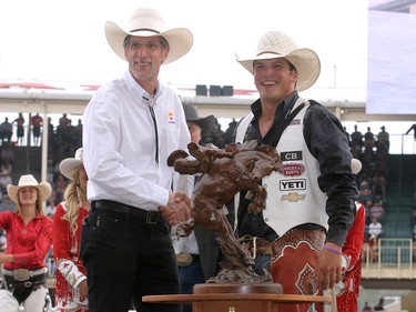 2017 Calgary Stampede Bareback Champion Richie Champion from Dublin, X, is presented with a cheque for $100,000 after winning the final day at the Stampede Rodeo. Sunday July 16, 2017 in Calgary, AB. DEAN PILLING/POSTMEDIA