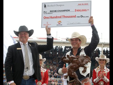 2017 Calgary Stampede Bareback Champion Richie Champion from Dublin, X, is presented with a cheque for $100,000 after winning the final day at the Stampede Rodeo. Sunday July 16, 2017 in Calgary, AB. DEAN PILLING/POSTMEDIA