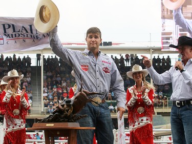 2017 Calgary Stampede Steer Wrestling Champion Tyler Waguespack from Gonzales, LA, is presented with a cheque for $100,000 after winning the final day at the Stampede Rodeo. Sunday July 16, 2017 in Calgary, AB. DEAN PILLING/POSTMEDIA