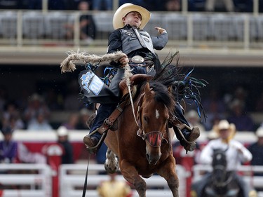 Zeke Thurston of Big Valley, Alberta rides Get Smart to win saddle bronc championship at the Calgary Stampede on Sunday July 16, 2017. Leah Hennel/Postmedia