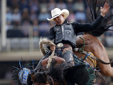 Zeke Thurston of Big Valley, Alberta rides Get Smart to win saddle bronc championship at the Calgary Stampede on Sunday July 16, 2017. Leah Hennel/Postmedia