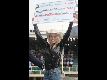 2017 Calgary Stampede Barrel Racing Champion Tiany Schuster is presented with a cheque for $100,000 after winning the final day at the Stampede Rodeo. Sunday July 16, 2017 in Calgary, AB. DEAN PILLING/POSTMEDIA