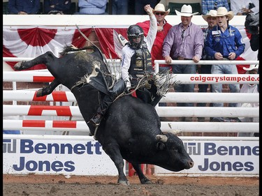 Sage Kimzey of Strong City, Oklahoma rides night Moves to win the bull riding championship at the Calgary Stampede on Sunday July 16, 2017. Leah Hennel/Postmedia