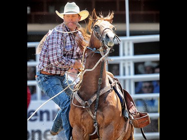Caleb Smidt of Bellville, Texas during the tie-down roping event at the Calgary Stampede rodeo. AL CHAREST/POSTMEDIA