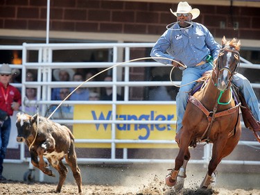 Fred Whitfield of Hockley,Texas during the tie-down roping event at the Calgary Stampede rodeo. AL CHAREST/POSTMEDIA