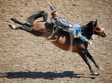 Manitoba cowboy Orin Larsen rides Saturn Rocket to a score of 86.50 during the bareback event at the 2017 Calgary Stampede rodeo. AL CHAREST/POSTMEDIA