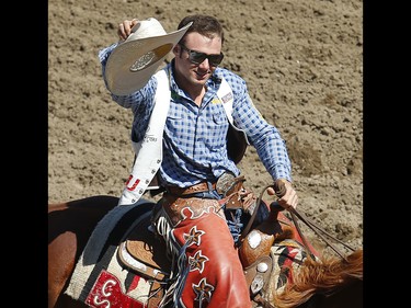 Utah cowboy Mason Clements makes the victory lap after riding Paradise Moon to a score of 87.50 points in the bareback event at the 2017 Calgary Stampede rodeo. AL CHAREST/POSTMEDIA