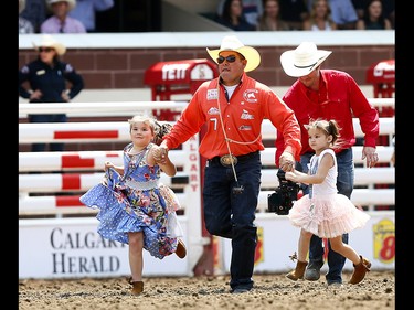 Cowboys bring out their kids during the grand entry on day 6 of the 2017 Calgary Stampede rodeo on  Wednesday July 12, 2017. DARREN MAKOWICHUK/Postmedia Network