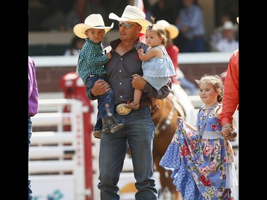 Cowboys bring out their kids during the grand entry on day 6 of the 2017 Calgary Stampede rodeo on  Wednesday July 12, 2017. DARREN MAKOWICHUK/Postmedia Network