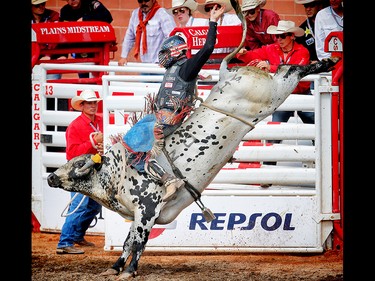 Prince Albert, Saskatchewan cowboy Tanner Byrne rides a bull called All Fired Up to a score of 84 points at the Calgary Stampede rodeo. AL CHAREST/POSTMEDIA