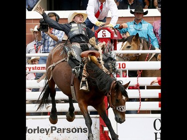 Rusty Wright from Milford, UT, riding Gone Country wins the Saddle Bronc event on day 6 of the 2017 Calgary Stampede rodeo on  Wednesday July 12, 2017. DARREN MAKOWICHUK/Postmedia Network