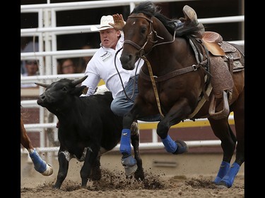Curtis Cassidy of Donalda, Alberta during steer wrestling at the Calgary Stampede on Saturday July 15, 2017. Leah Hennel/Postmedia