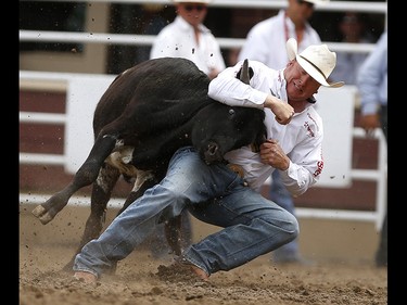 Curtis Cassidy of Donalda, Alberta during steer wrestling at the Calgary Stampede on Saturday July 15, 2017.