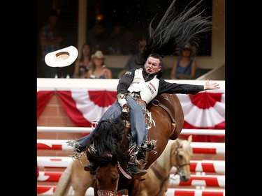 Steven Peebles of Redmond, Oregon rides You See Me to the finals during bareback at the Calgary Stampede on Saturday July 15, 2017. Leah Hennel/Postmedia