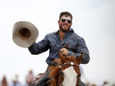 Cort Scheer during his victory lap, Saturday July 15, 2017, after advancing to the saddle bronc finals at the Calgary Stampede. Leah Hennel/Postmedia
