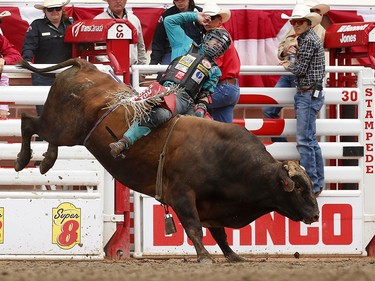 Mike Lee of Fort Worth, Texas rides All About You during bull riding at the Calgary Stampede, Saturday July 15, 2017 to advance to the finals. Leah Hennel/Postmedia