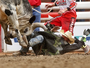 Chase Outlaw of Hamburg, Arizona is bucked off  Tequila during bull riding at the Calgary Stampede, Saturday July 15, 2017. Leah Hennel/Postmedia