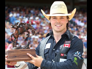 Calgary cowboy Connor Hamilton poses for a photo with his trophy bronze after winner the 2017 novice bareback competition at the Calgary Stampede rodeo. AL CHAREST/POSTMEDIA