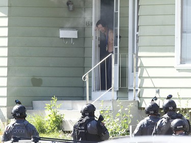 Calgary Police take a man into custody after they responded to an incident in 4500 blk of 7 Ave SE related to a stabbing in Calgary on Tuesday July 4, 2017. A stand off with a suspect lasted hours as negotiators dealt with a suspect. Police stormed the house about 5 pm and took one man into custody. Jim Wells//Postmedia