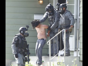 Calgary Police take a man into custody after they responded to an incident in 4500 blk of 7 Ave SE related to a stabbing in Calgary on Tuesday July 4, 2017. A stand off with a suspect lasted hours as negotiators dealt with a suspect. Police stormed the house about 5 pm and took one man into custody. Jim Wells//Postmedia