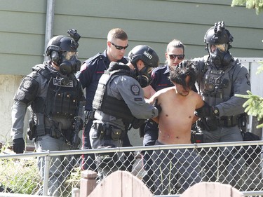 Calgary Police take a man into custody after they responded to an incident in 4500 blk of 7 Ave SE related to a stabbing in Calgary on Tuesday July 4, 2017. A stand off with a suspect lasted hours as negotiators dealt with a suspect. Police stormed the house about 5 pm and took one man into custody. Jim Wells//Postmedia