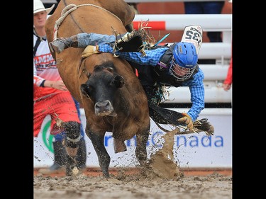 Kade McDonald from Melville SK heads for the mud in the junior steer riding event at the Calgary Stampede rodeo, Tuesday  July 11, 2017. GAVIN YOUNG/POSTMEDIA