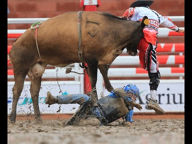 Kade McDonald from Melville SK goes into the mud in the junior steer riding event at the Calgary Stampede rodeo, Tuesday  July 11, 2017. GAVIN YOUNG/POSTMEDIA