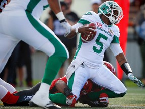 Calgary Stampeders Charleston Hughes brings down quarterback Kevin Glenn of the Saskatchewan Roughriders during CFL football on Saturday, July 22, 2017. Al Charest/Postmedia