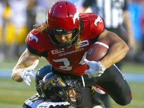 The Stamps' Ante Milanovic-Litre scores a rushing TD during CFL action between the Hamilton Tiger Cats and the Calgary Stampeders in Calgary at McMahon Stadium Saturday, July 29, 2017. Jim Wells/Postmedia