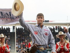 2017 Calgary Stampede steer wrestling champion Tyler Waguespack from Gonzales, LA, is presented with a cheque for $100,000 after winning the final day at the Stampede Rodeo. Sunday July 16, 2017 in Calgary.