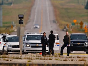 Police examine the scene west of Calgary near Highway 8 were a body was discovered early  on Wednesday July 12, 2017.