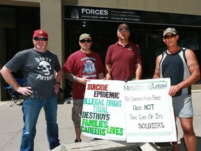(L-R) Veterans Todd Gilman, Dana Johnson, Dave Bona and Christian McEachern protest in front of the Canadian Forces Recruiting office in downtown Calgary on Thursday July 13, 2017. The group were voicing their opinion on the military's use of a malaria drug. Jim Wells/Postmedia
Jim Wells, Jim Wells/Postmedia