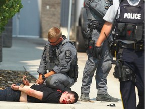 Calgary Police and RCMP take one of two people into custody at CrossIron Mills north of Calgary on Wednesday July 19, 2017.